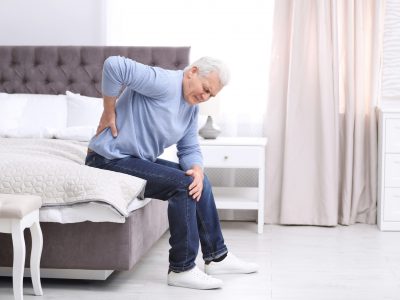 Senior,Man,Suffering,From,Back,Pain,At,Home